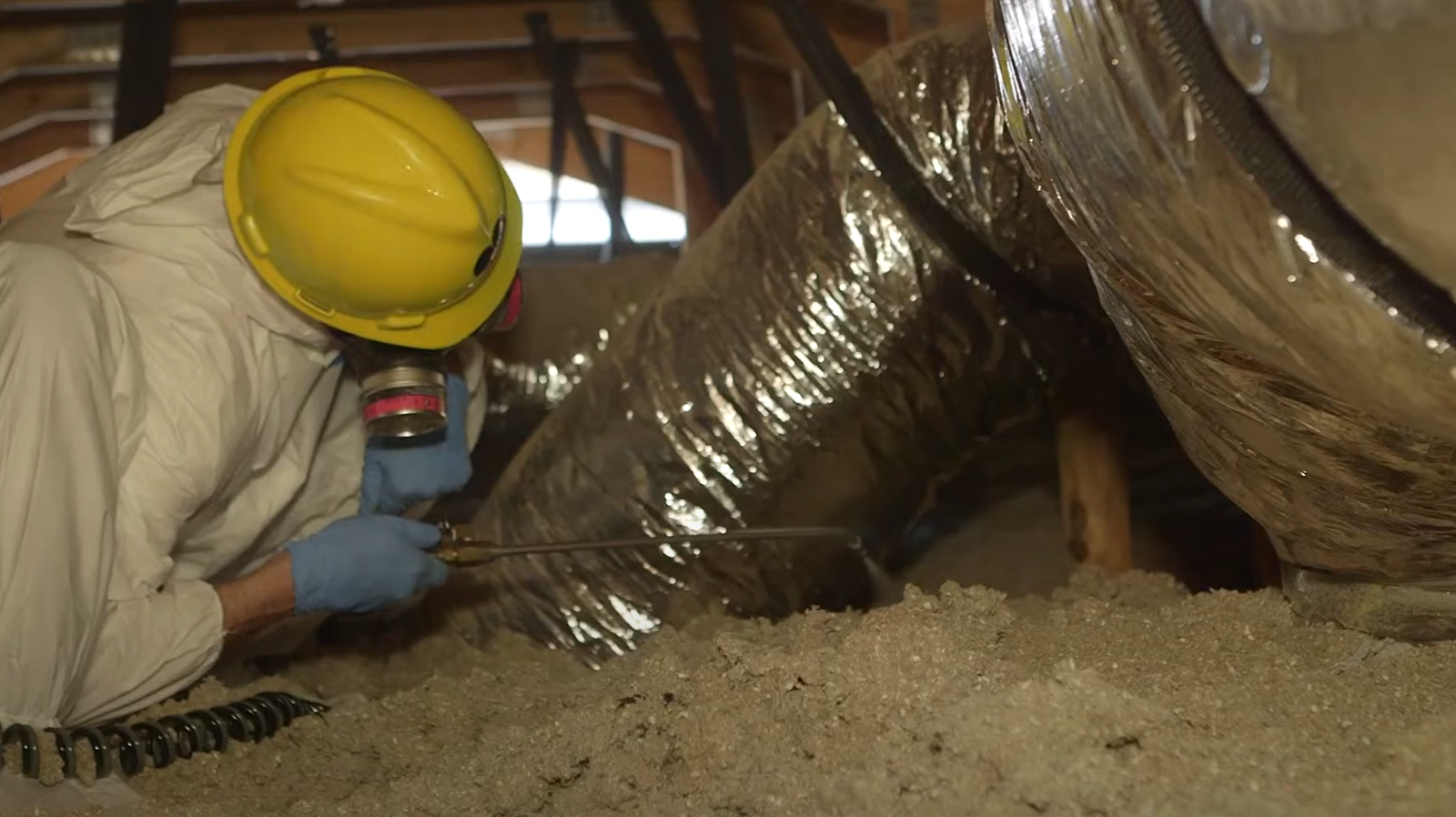 Pest control worker spraying insulation in attic for Rodent Control in Philadelphia